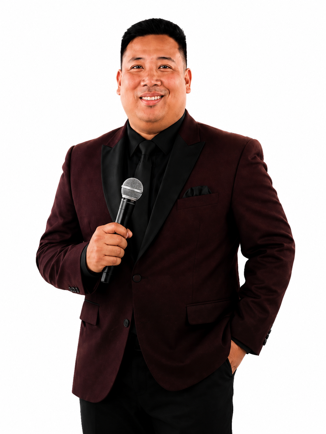 Portrait of Host Kenj in formal event attire holding a microphone